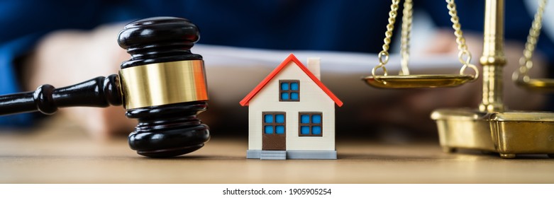 House Property Auction After Divorce. Judge Reading Mortgage Document