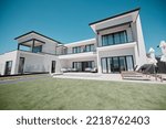 House, property and elderly couple on a balcony, relax and bonding at their dream home. Real estate, family house and retirement by senior man and woman standing, hug and talking on a terrace