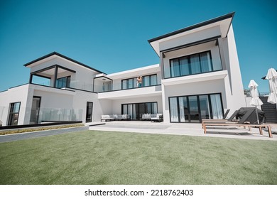 House, property and elderly couple on a balcony, relax and bonding at their dream home. Real estate, family house and retirement by senior man and woman standing, hug and talking on a terrace - Powered by Shutterstock