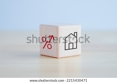 House and property investment and asset management concept. Loan, Mortgage, Inflation, Sale and tax rise. House icon and percentage sign on wooden block. Home price or increase of interest rate.