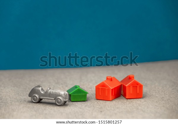 the house is red and green with a\
gray car standing next to it, the concept of a rich\
man
