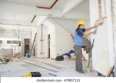 House Renovation Concept. Asian Construction Worker With Hardhat Working.