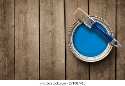 House renovation, paint can on the old wooden background with copy space