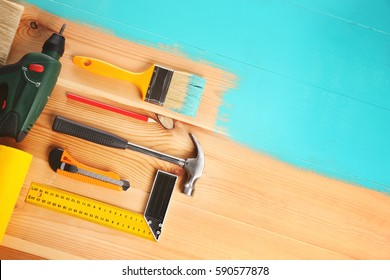 House Renovation Tools On Turquoise Painted Wooden Background