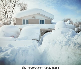 A House, Roof And Cars Are Covered With Deep White Snow In Western New York For A Weather Or Blizzard Concept.