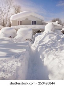 A House, Roof And Cars Are Covered With Deep White Snow In Western New York For A Weather Or Blizzard Concept.