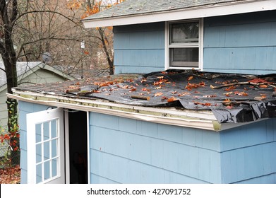 house roof damaged in hurricane storm