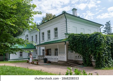 House of russian writer Leo Tolstoy and a girl in front of it. Yasnaya Polyana, Tula Oblast, Russia.