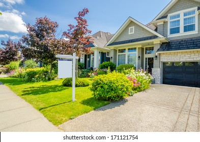 House For Sale. Real Estate Sign In Front Of A House.