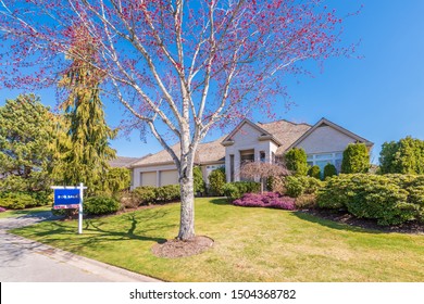 House For Sale In Vancouver, Canada. Real Estate Sign In Front Of A House.