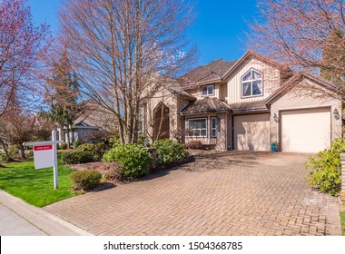 House For Sale In Vancouver, Canada. Real Estate Sign In Front Of A House.