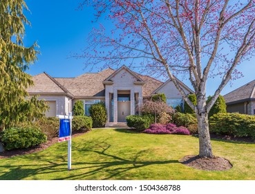 House For Sale In Vancouver, Canada. Real Estate Sign In Front Of A House.