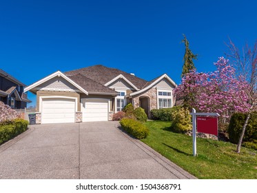 House For Sale In Vancouver, Canada. Real Estate Sign In Front Of A House.