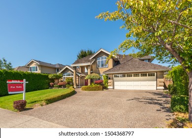 House For Sale In Vancouver, Canada. Real Estate Sign In Front Of A House.