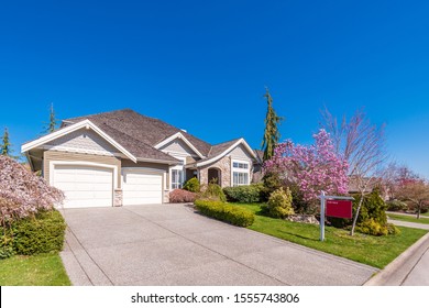 House For Sale In Vancouver, Canada. Real Estate Sign In Front Of A House.