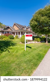 House For Sale In Vancouver, Canada. Real Estate Sign In Front Of A House.