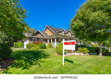 House For Sale In Vancouver, Canada. Real Estate Sign In Front Of A House.