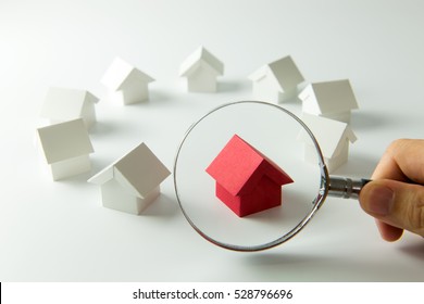 House searching concept with a magnifying glass
