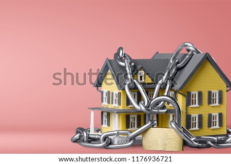 House security concept. House in chains isolated