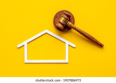 House shape with judges gavel. Insurance mortgage law concept