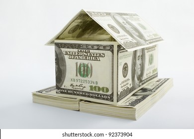 House shape made from 100 dollar bills over white background - Powered by Shutterstock