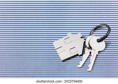 House Shaped Keychain And Keys On Desk