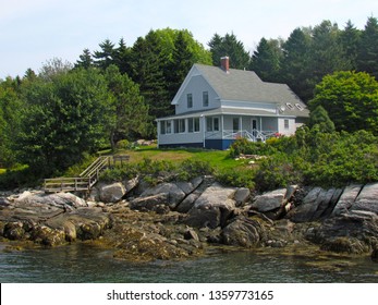 A House Sitting On The Rocky Shorelines Of Cliff Island In The Casco Bay Off The Coast Of Maine