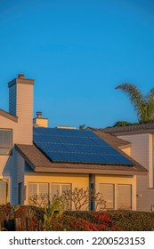 House With Solar Panels On Roof At Del Mar Southern California Against Blue Sky. Exterior View Of A Beach Home With Renewable Green Energy Source At A Seaside Neighborhood.