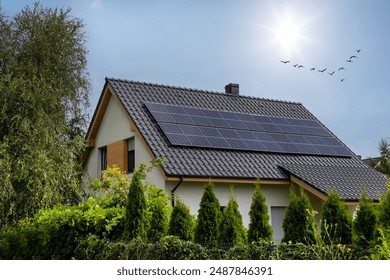 House with Solar Panels on Roof - Powered by Shutterstock