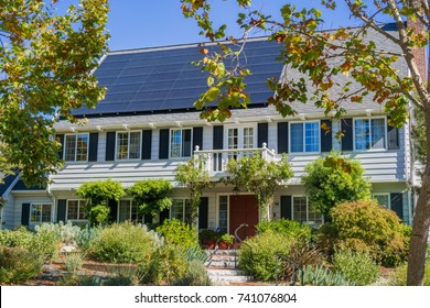 House With Solar Panels On The Roof In A Residential Neighborhood Of Oakland, In San Francisco Bay On A Sunny Day, California