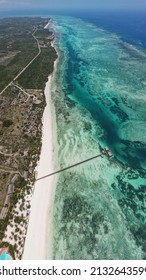 House Standing On A Coral Reef At Low Tide In The Ocean With A Bridge To The Beach Zanzibar