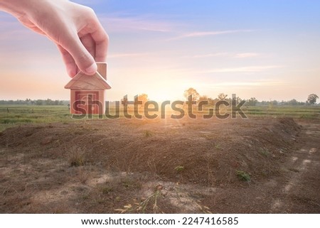 House symbol with location pin and Empty dry cracked swamp reclamation soil, land plot for housing construction project with and beautiful blue sky with fresh air Land for sales landscape concept