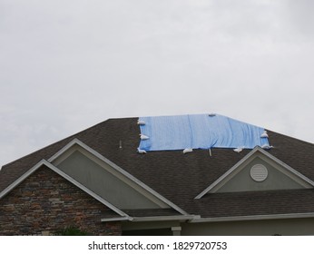 House With A Tarp Over Leak