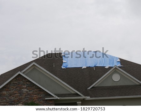 House with a Tarp Over Leak
