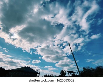 House And Telephone Pole Shadow. Blue Sky.