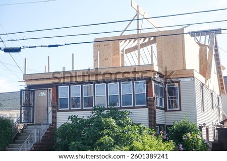 House that is in the process of having a second floor built onto it.