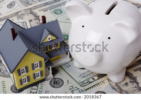 House with twenty dollar bills background and piggy bank