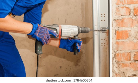 House Under Construction Concept. Panoramic And Cropped View Of Professional Worker Holding Electric Drills In Hands, Making Hole In Brick Copy Space Wall, Install Metal Rail On Garage Door System