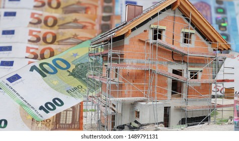 House under construction with Euro banknotes in background
