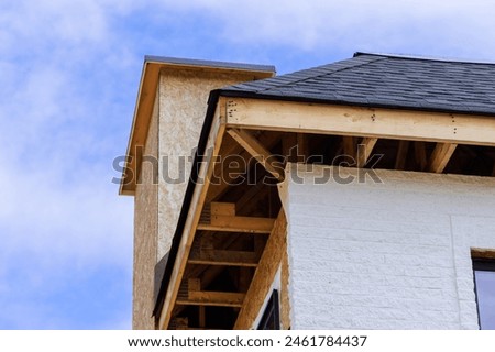 As house is under construction, joist framework gutter holders soffit fascia trim is being installed