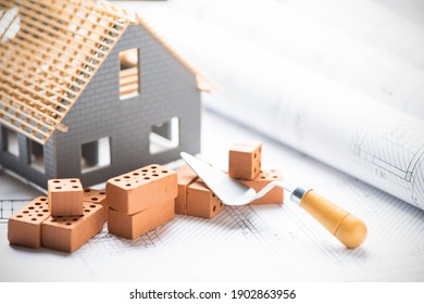 House under construction on blueprints close up. Building project concept - Shutterstock ID 1902863956