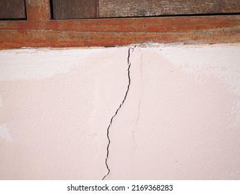 House Wall Crack Near Window Frame. Closeup Photo, Blurred.