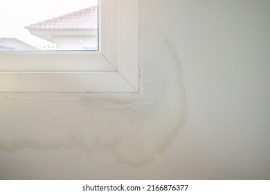 house wall near the window with some water stain show peeling paint