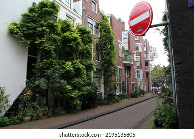 House Wall Overgrown With Ivy In A Side Street In Amsterdam Next To A No Entry Sign