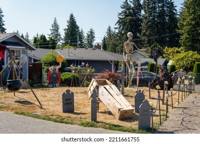 House Yard Decorated For Halloween With Skulls, Skeleton, Graves, Wooden Coffin, Tombstones, Pirate Ship. Everett, WA, USA - September 2022