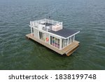 A houseboat on a lake in the city, a place of snouth and entertainment.