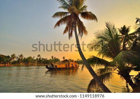 A houseboat sailing in kerala backwaters during sunset.