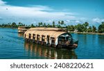 Houseboats on a sunny day in beautiful lake Vembanad kayal  in Alappuzha, Kerala, India.