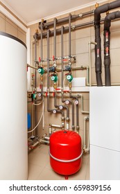 Household boiler house with heat pump, barrel; Valves; Sensors and an automatic control unit. - Shutterstock ID 659839156