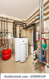 Household boiler house with heat pump, barrel; Valves; Sensors and an automatic control unit. - Shutterstock ID 659839159